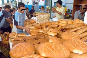 Tunisians buy bread at a central market in Tunis, 24 September 2006, on the first day of the Muslim Holy month of Ramadan. Muslims all over the world are supposed to go without food, drink, smokes and sex and to refrain from impure thoughts from sunrise to sunset, in order to purify themselves and concentrate their mind on Islamic teachings. AFP PHOTO/FETHI BELAID (Photo credit should read FETHI BELAID/AFP/Getty Images)